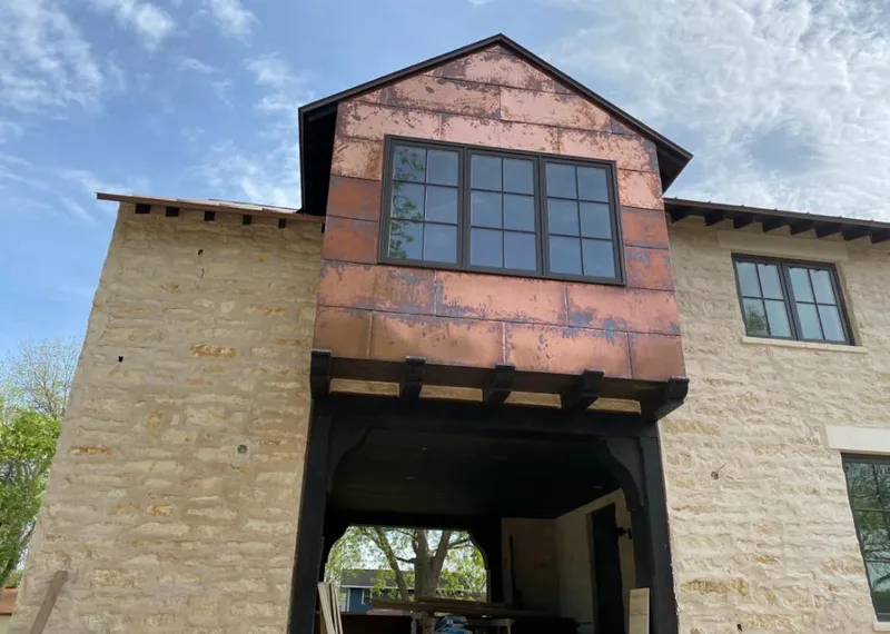 Copper metal panel facade on a stone building for Skylight Installation in Oakfield